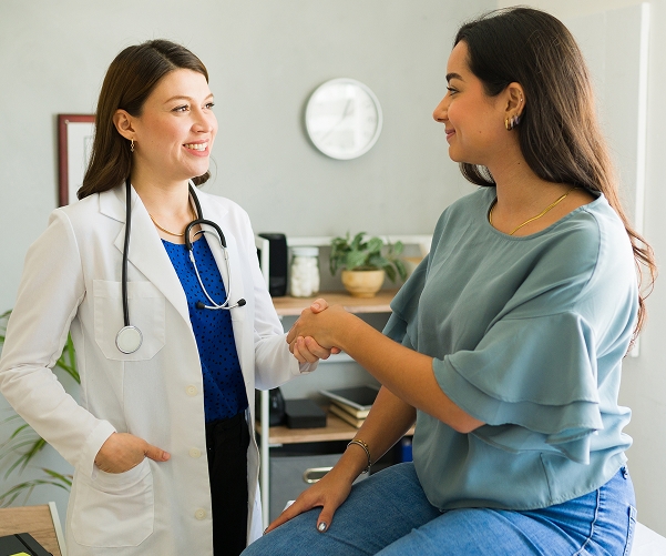 Doctor shaking hands with a female patient