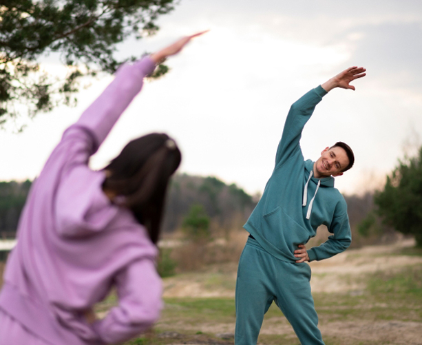 Two people stretching outdoors